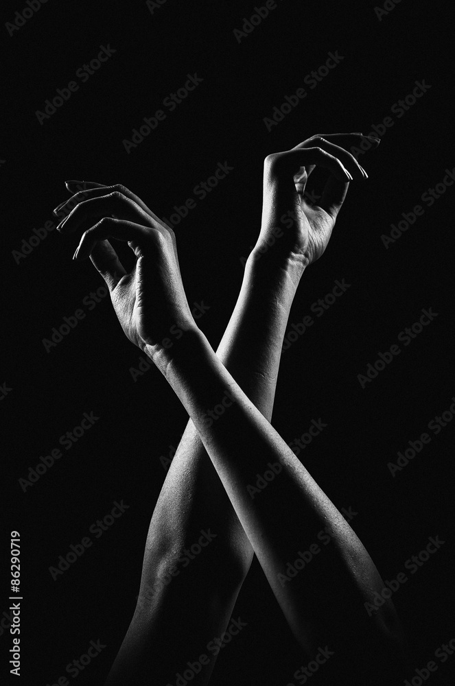 Obraz premium The outline of a beautiful female hand on a black background