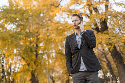 Young man with mobile phone...