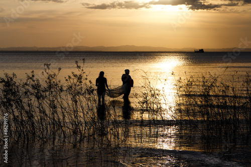 cross-light of people in lake, ometepe, Nicaragua