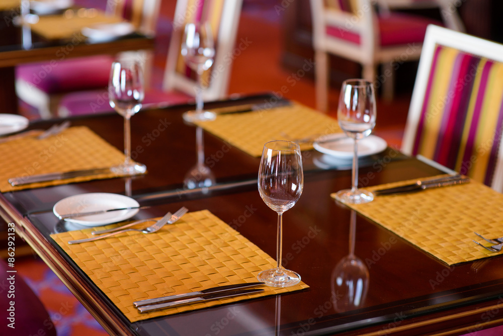 Served wooden table in a restaurant/Wooden table in a restaurant with empty wine glasses and napkins Served wooden table in a restaurant/Wooden table in a restaurant with empty wine glasses and napkins
