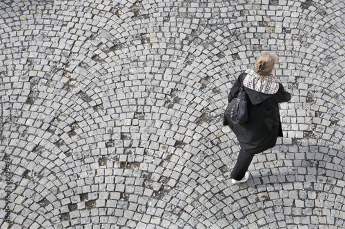 Older women walking on cobblestone bird perspective