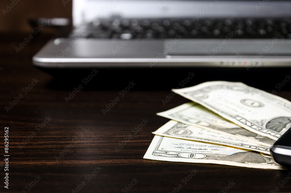 American dollars money and laptop computer American dollars money and laptop computer