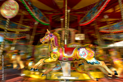Motion blurr of vintage horse of amusement ride on merry-go-roun