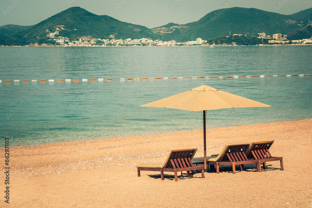 Beautiful beach with sunshades in Montenegro, Balkans, Adriatic Sea.