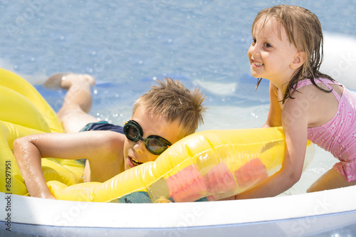 Summertime and swimming activities for happy children on the pool