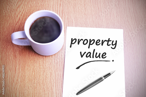 Coffee on the table with note writing property value