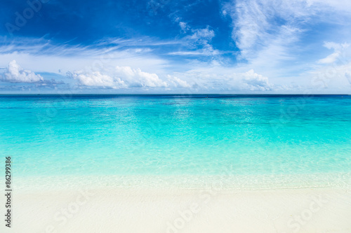 tropical paradise beach with crystal clear, turquoise blue water, wonderful clouds and sky © stockphoto-graf