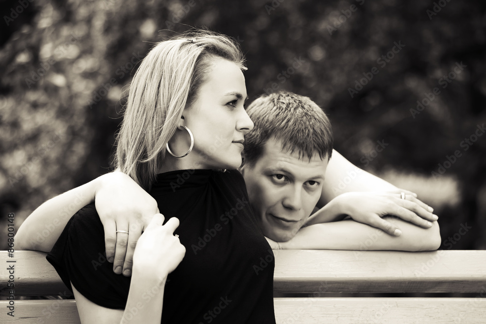 Happy young couple in love on the bench Happy young couple in love on the bench