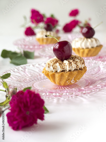 Cupcake with cherries, whipped cream and flowers