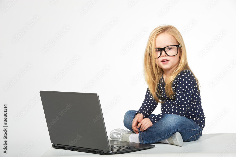 Beautiful little girl learning at the computer Beautiful little girl learning at the computer