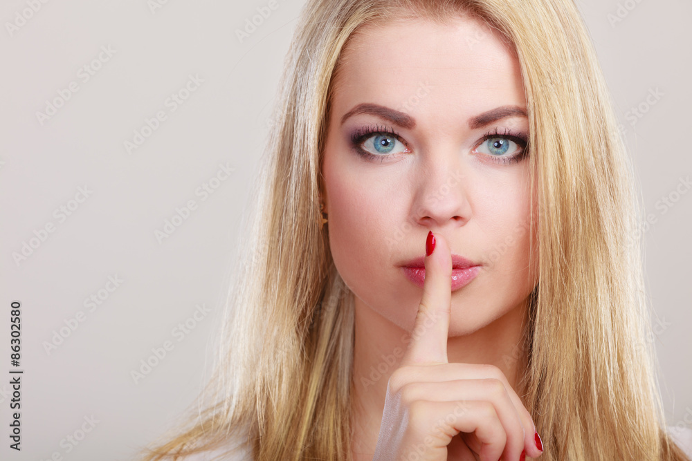 Woman asking for silence finger on lips hush hand gesture. Woman asking for silence finger on lips hush hand gesture.