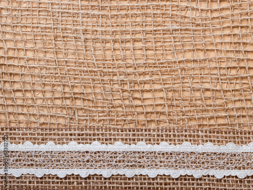 Lace ribbon on burlap cloth background