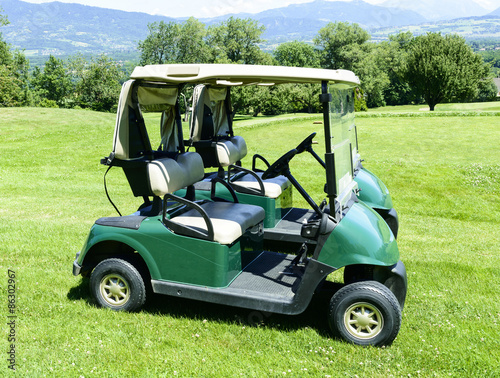 two green golf cars