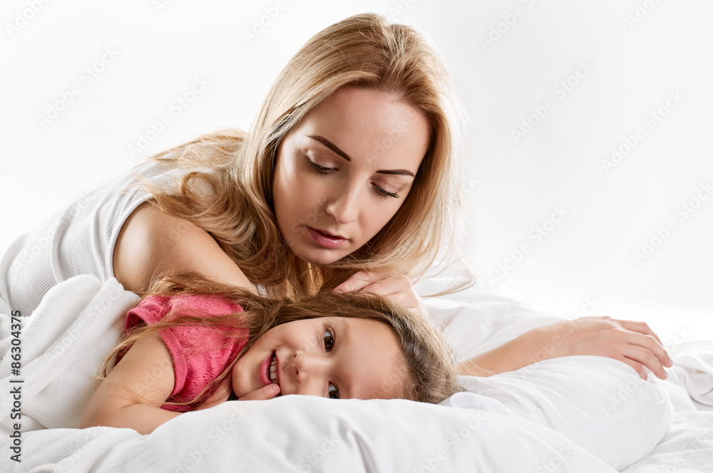Woman and daughter lying in bed Woman and daughter lying in bed