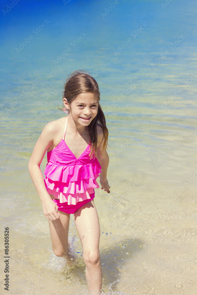 Cute Girl Playing in the Ocean water on Vacation Cute Girl Playing in the Ocean water on Vacation