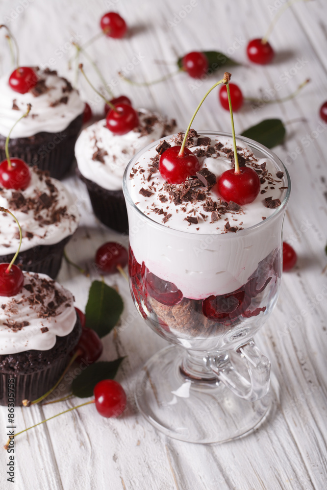 Dessert cherry black forest and cupcakes close-up. Vertical
Dessert cherry black forest and cupcakes close-up. Vertical