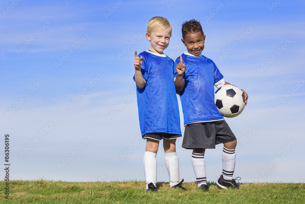 Two diverse young soccer players showing No. 1 sign. Full length view of two youth recreation league soccer players Two diverse young soccer players showing No. 1 sign. Full length view of two youth recreation league soccer players