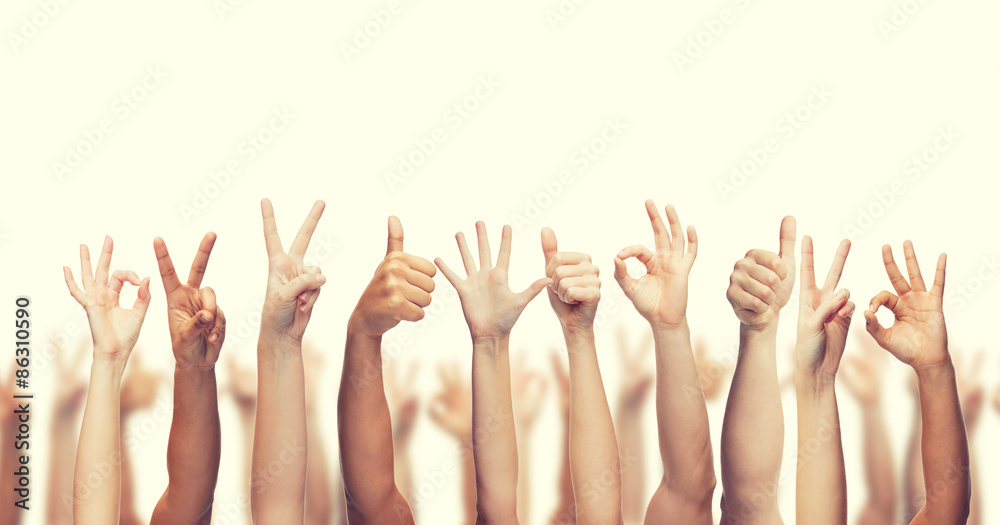human hands showing thumbs up, ok and peace signs