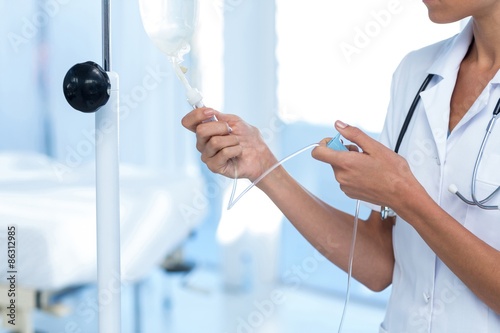 Nurse connecting an intravenous drip photo