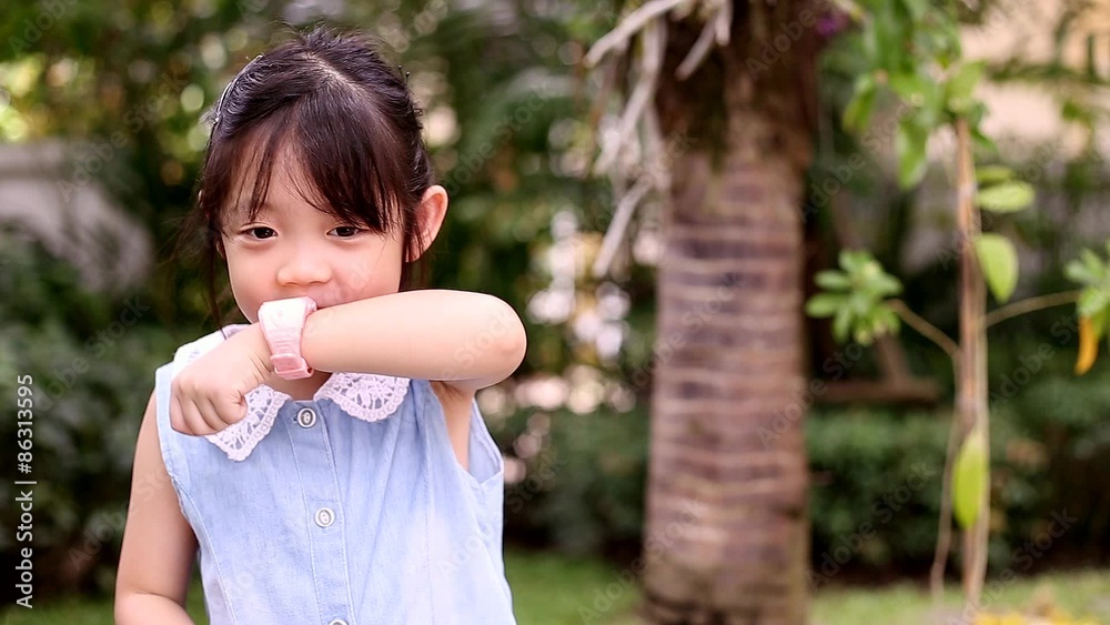 Little Girl Talking with Parent via Smart Watch While Being Alone in Park Little Girl Talking with Parent via Smart Watch While Being Alone in Park