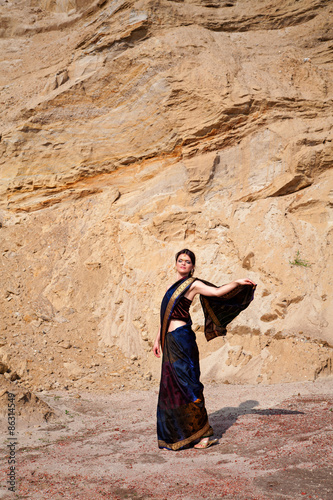 Beautiful girl in indian style against sand background © Alena Stalmashonak