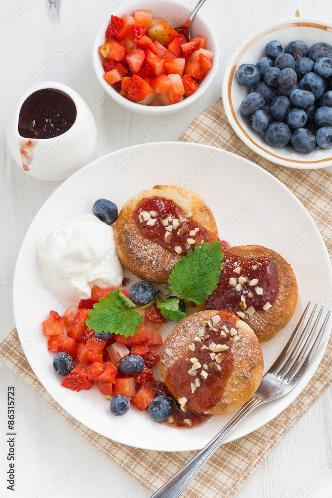 sweet cheese pancakes with fresh berries and cream