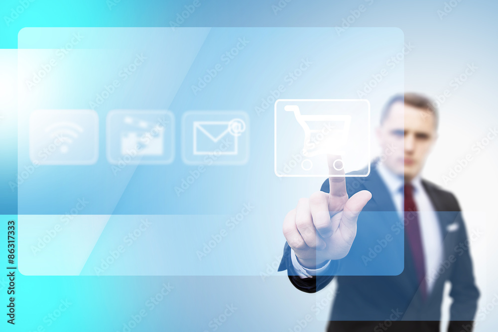 businessman pushing a button on a touch screen interface for online shopping businessman pushing a button on a touch screen interface for online shopping