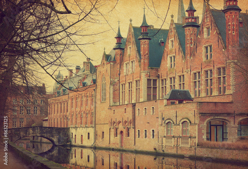 A canal in Bruges , Belgium. Photo in retro style. Added paper texture..