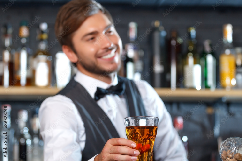 Handsome bartender during work