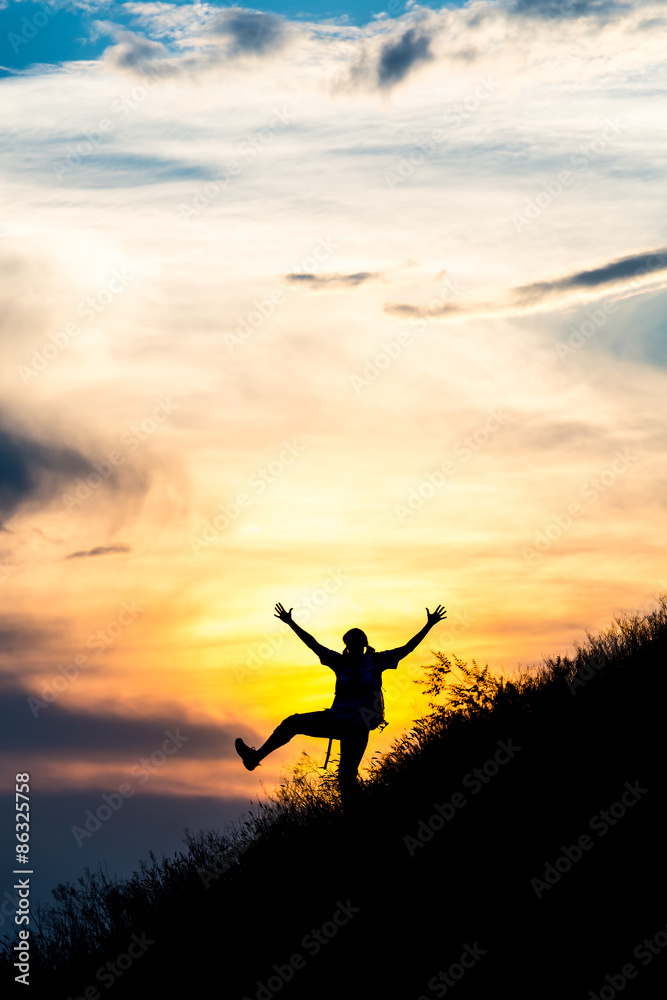 Happy female silhouette making funny dance.
Woman making dancing moves on steep grassy hill with gorgeous sunset sky and cloudscape on background Happy female silhouette making funny dance.
Woman making dancing moves on steep grassy hill with gorgeous sunset sky and cloudscape on background