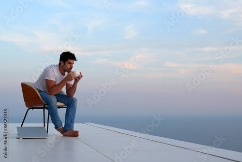 Wallpaper Mural relaxed young man at home on balcony Torontodigital.ca