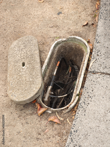 Melbourne, Australia - 2015, April 12: Typical roadside pit with Hybrid Coaxial Fiber (HFC) cable used for cable TV and internet via the Multi Technology Mix photo