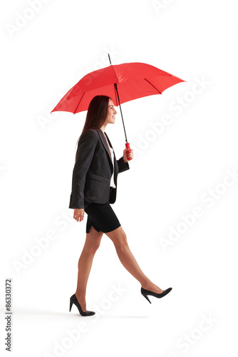 woman walking under red umbrella