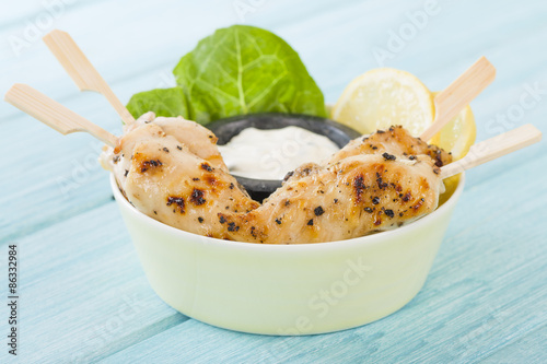 Chicken Satay - Char-grilled spicy mini chicken fillet skewers served with lemon and aioli dip.
 photo