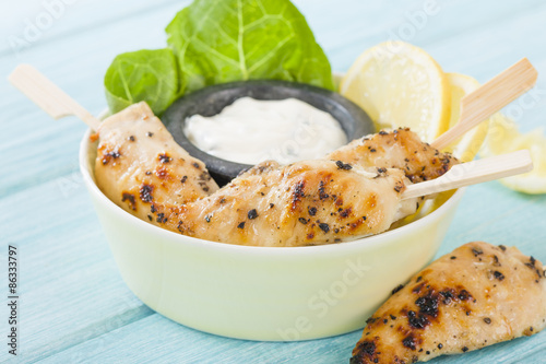 Tableau sur toile Chicken Satay - Char-grilled spicy mini chicken fillet skewers served with lemon and aioli dip