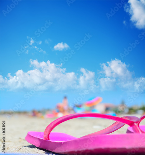 flip flops under a blue sky with clouds