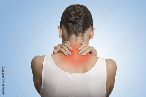 Back spine disease. Closeup view tired female massaging her neck photo