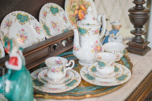 Antique floral tea set on a white tablecloth