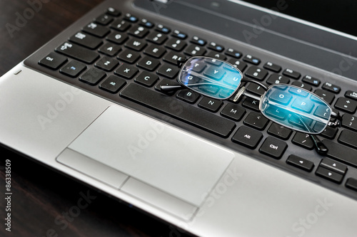 Wallpaper Mural Close up pair of glasses on the laptop keyboard Torontodigital.ca