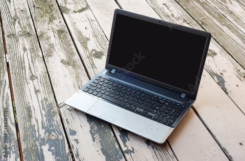 Closeup laptop computer on wooden floor. selective focus image