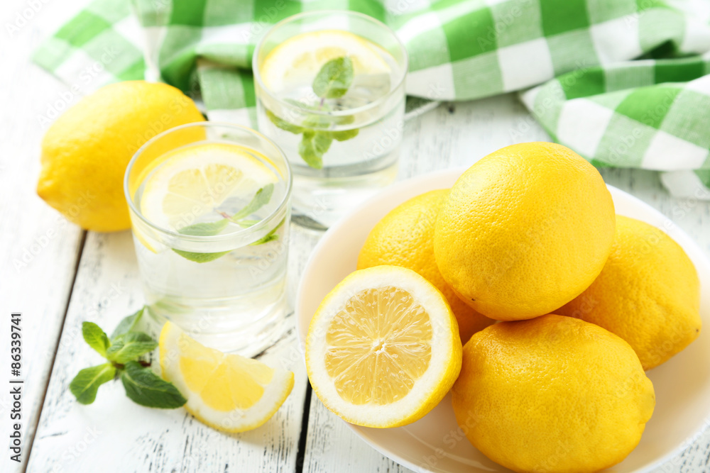 Fresh lemonade with lemon on white wooden background Fresh lemonade with lemon on white wooden background