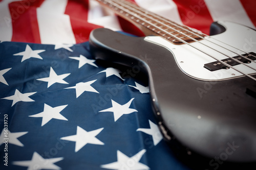 Vintage Bass guitar body on american flag background. selective focus image with shallow depth of field