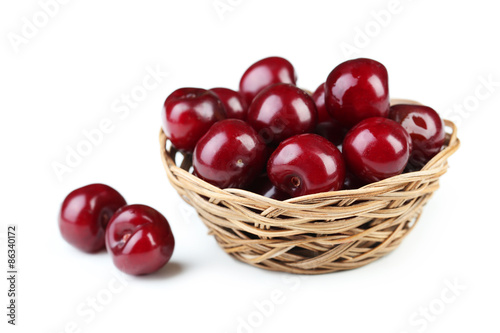 Ripe cherry in basket on white background