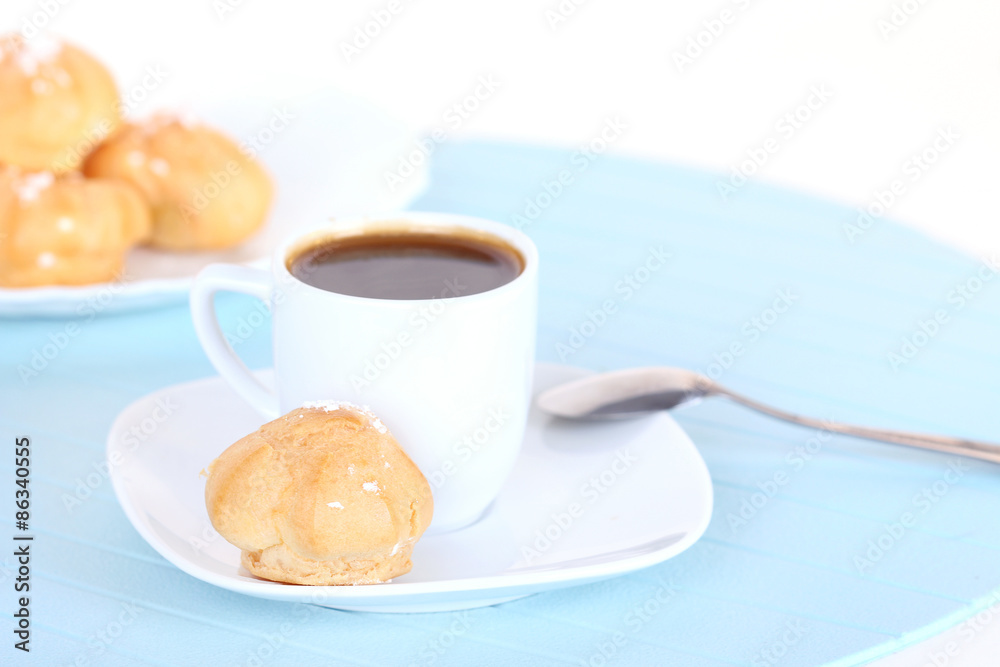 Cup of coffee and cakes on blue mat Cup of coffee and cakes on blue mat