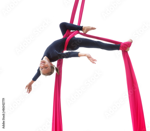 cheerful child training on aerial silks