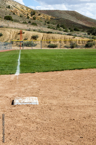 View looking down the third base line with third base at a softball diamond in New Mexico