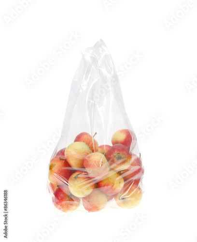 Apples in plastic bag isolated on white.