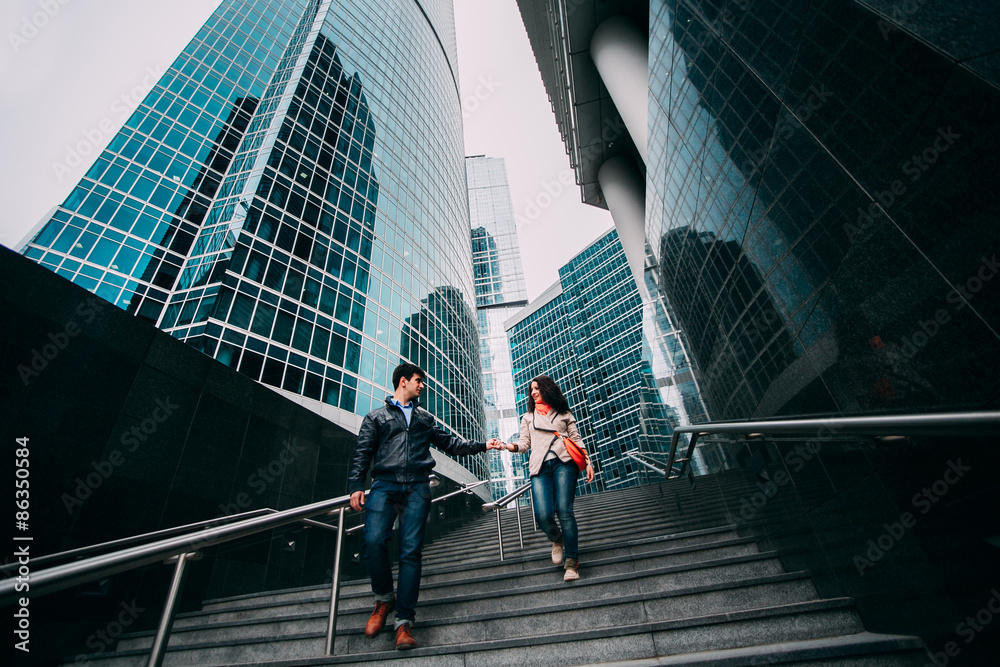 Young couple walking near the skyscrapers in Moscow