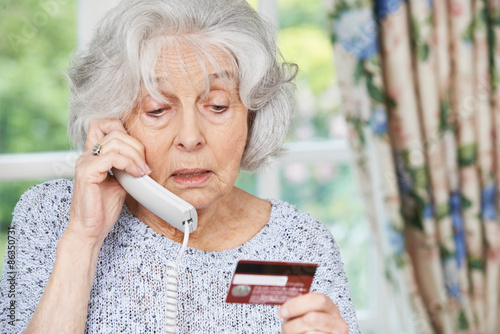 Fényképezés Senior Woman Giving Credit Card Details On The Phone