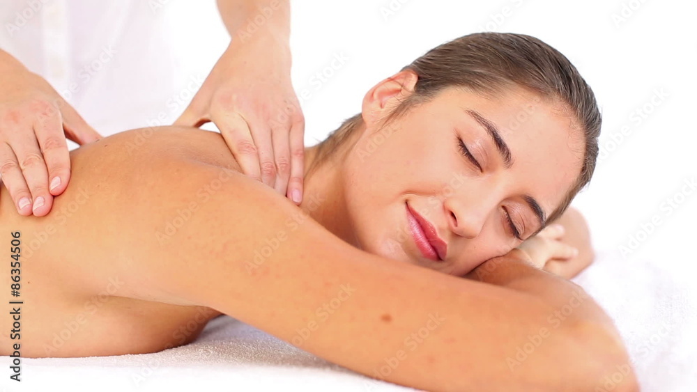 Attractive woman receiving back massage at spa center Attractive woman receiving back massage at spa center